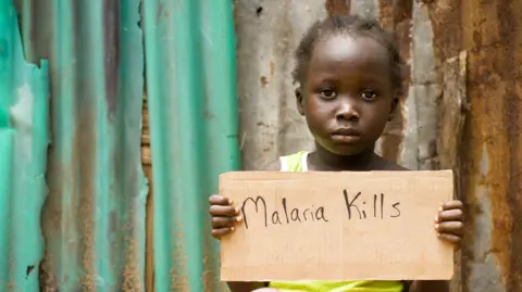 Getty Images Child holding a sign that reads 