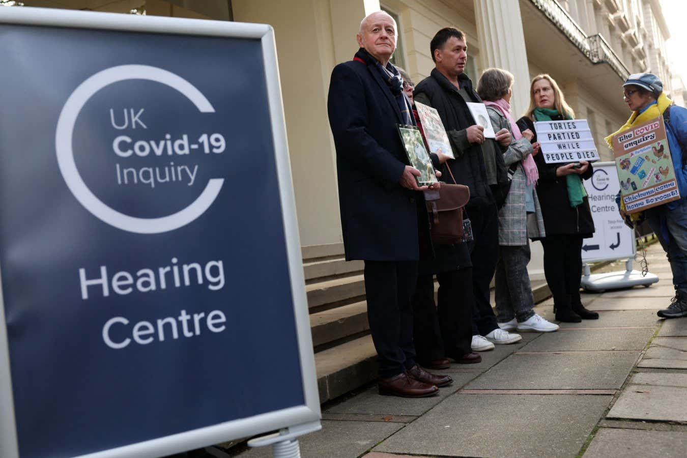 People demonstrating outside of the venue for the UK Covid-19 Inquiry in London in October 2023