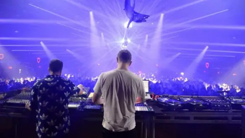 Getty Images Bicep performing on stage in California with a light display and dancing fans