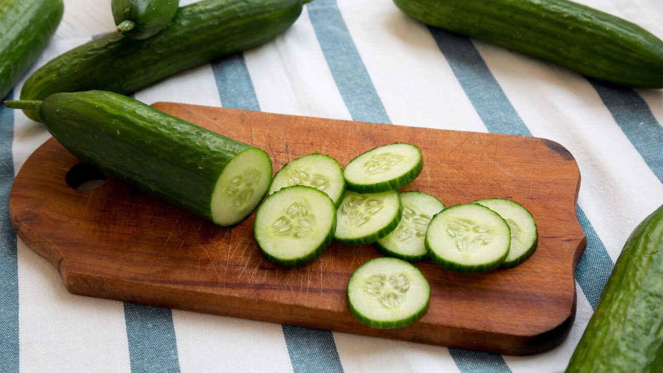 Sliced cucumber on a cutting board.