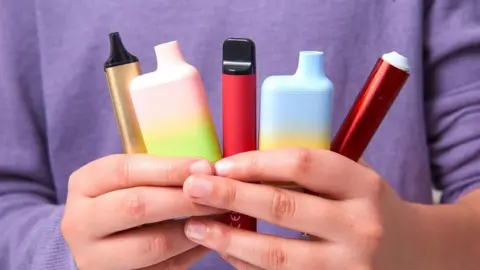 Getty Images Child holding colourful vapes