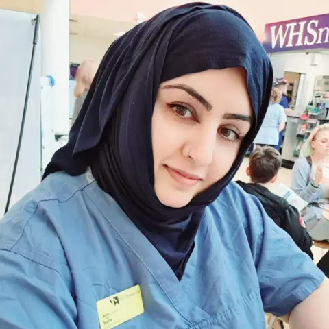 Safia Ahmadei wearing her student nurse uniform. 