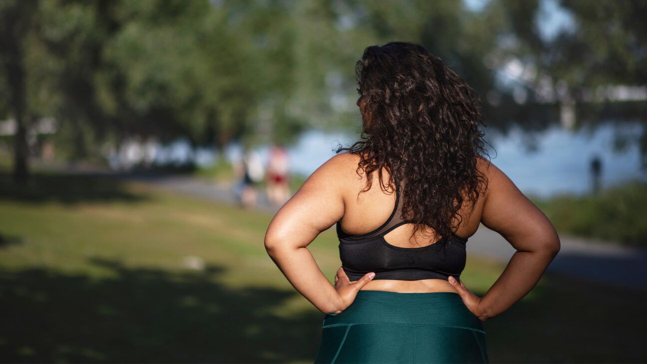 Rearview of a female exercising in a park