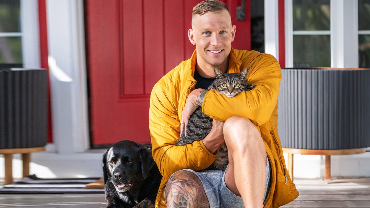 Caeleb Dressel with his cat and dog.