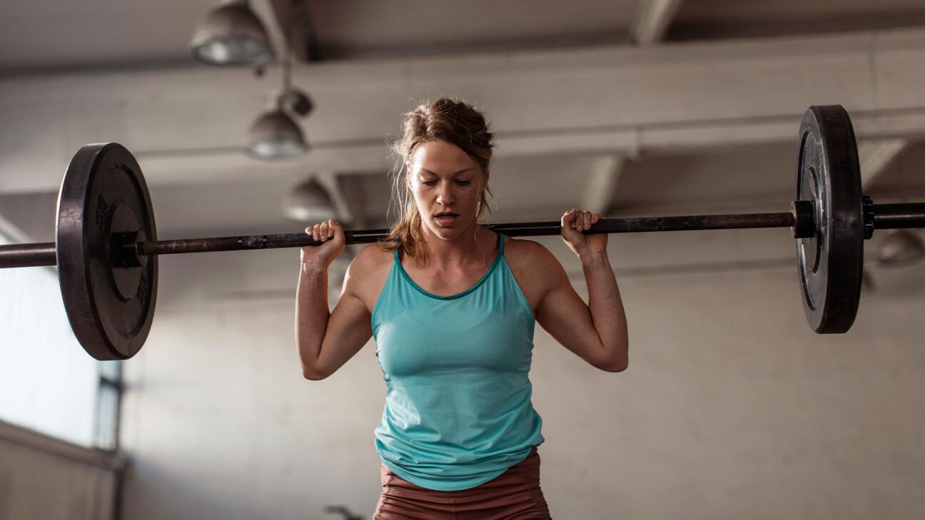 Female lifting barbell weights