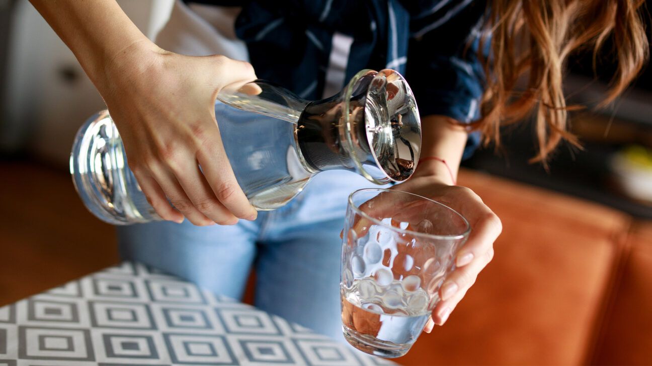 A female pouring water.