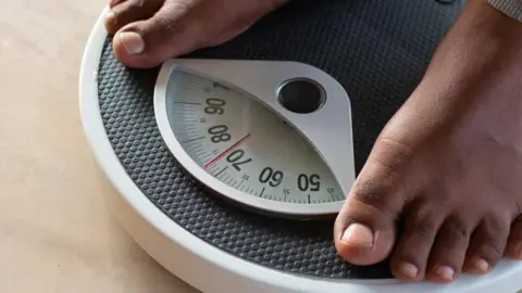 Getty Images Person on weighing scales