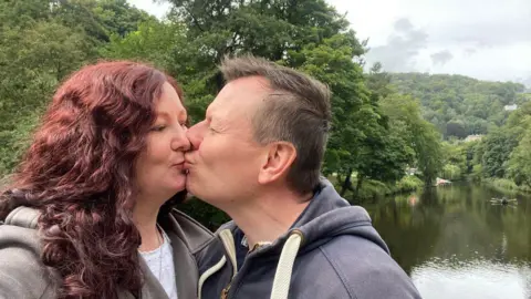 Cassandra Wardle Cassandra and her husband kissing in the countryside