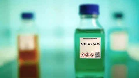 Getty Images small bottle of methanol with a blurred background