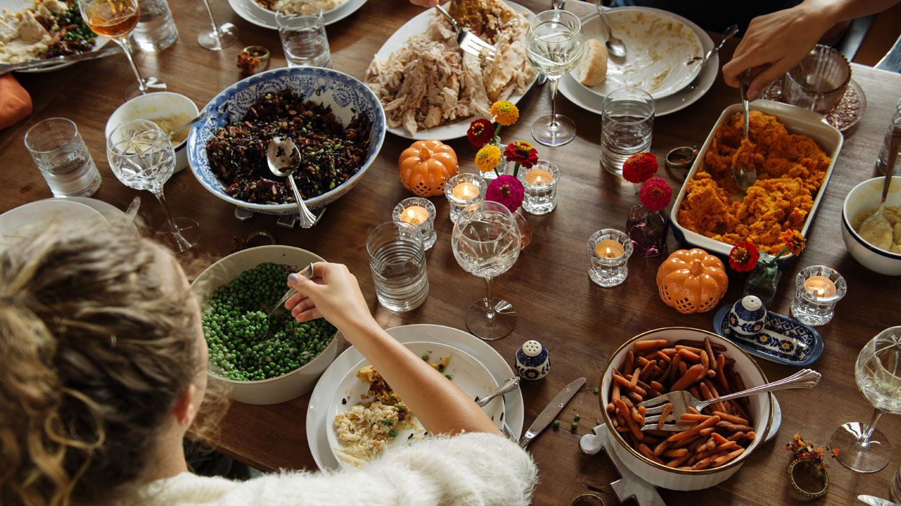 People sitting around a table eating a meal.