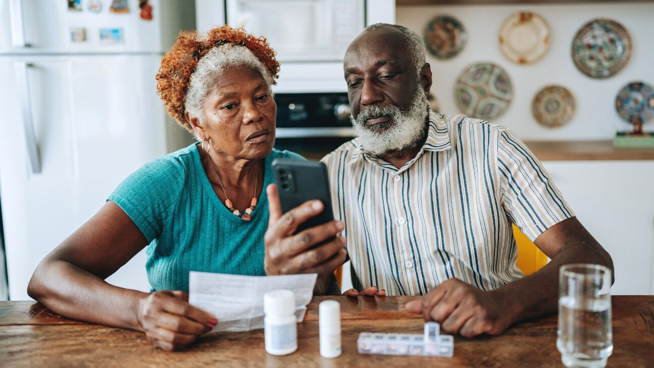 Older couple viewing prescription drugs, smartphone