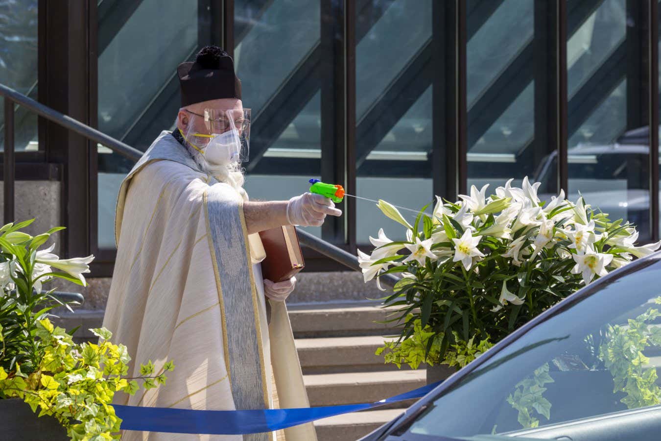 A priest conducted the blessing of the Easter Baskets using a water gun to distribute holy water in Grosse Pointe Park, Michigan, on 11 April 2020