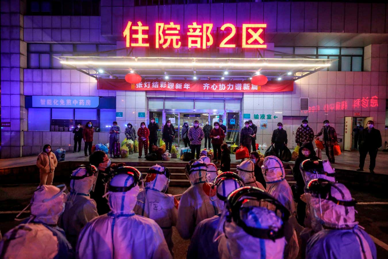 People with covid-19 wait to be transferred from Wuhan No.5 Hospital to Leishenshan Hospital, the newly-built hospital for the pandemic in Wuhan, China, on 3 March 2020