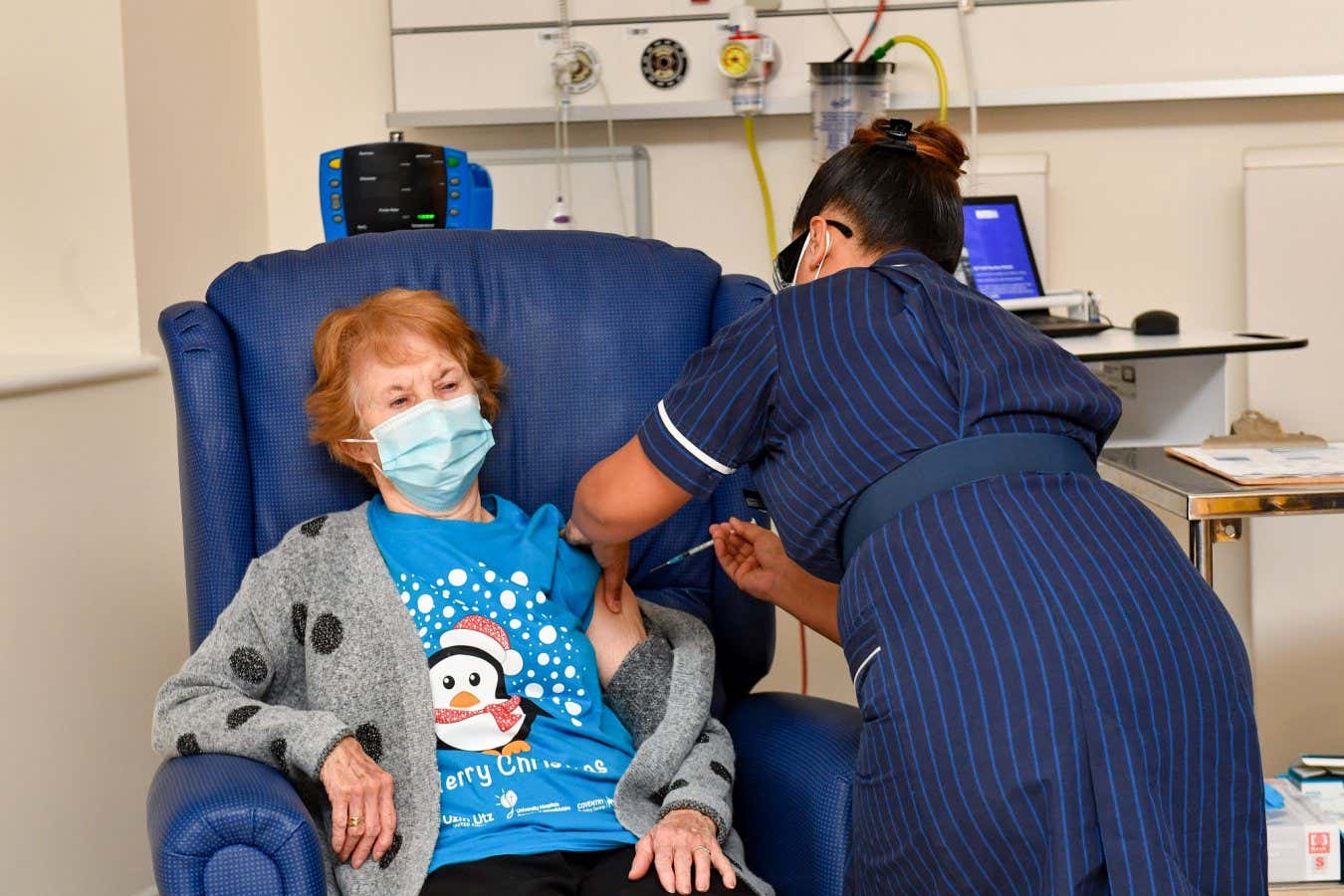 Margaret Keenan receiving the Pfizer-BioNTech covid-19 vaccine in Coventry, UK, in December 2020 - the first person to be immunised against the infection outside of a clinical trial