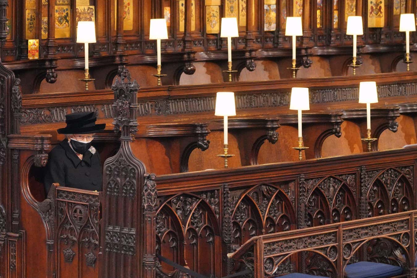 Queen Elizabeth II sitting alone at her husband Prince Philip's funeral at Windsor Castle, UK, on 17 April 2021