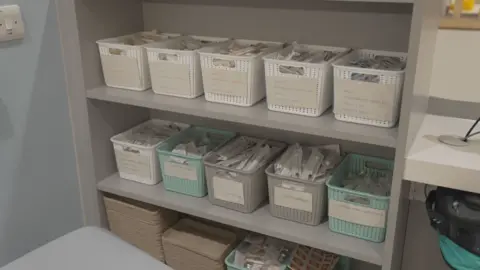 Medical equipment is safely packed in individual wrapping and in plastic boxes stacked on shelves.