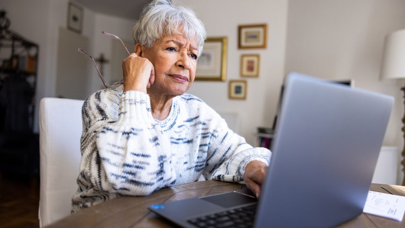 Concerned older female with laptop