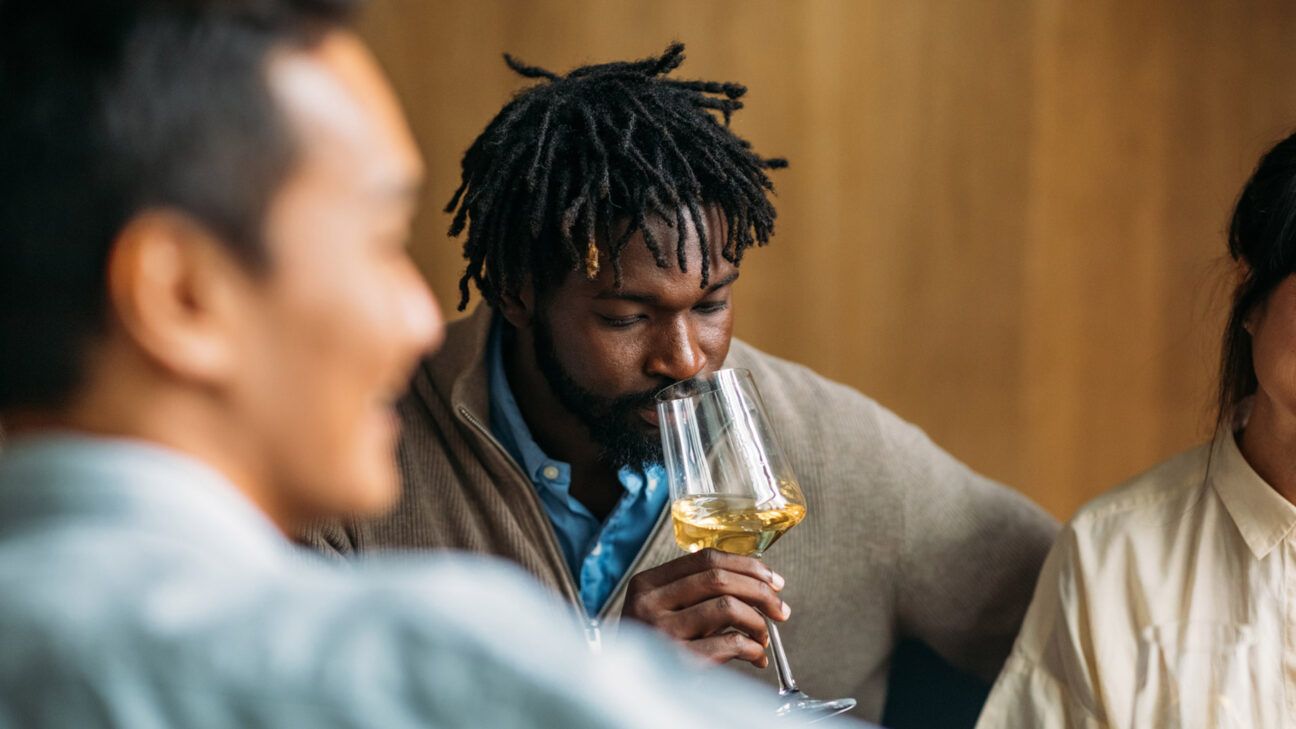 Male drinking wine with friends