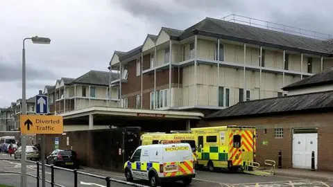 Geograph/David Dixon stock image showing police van and ambulances outside the hospital buildings