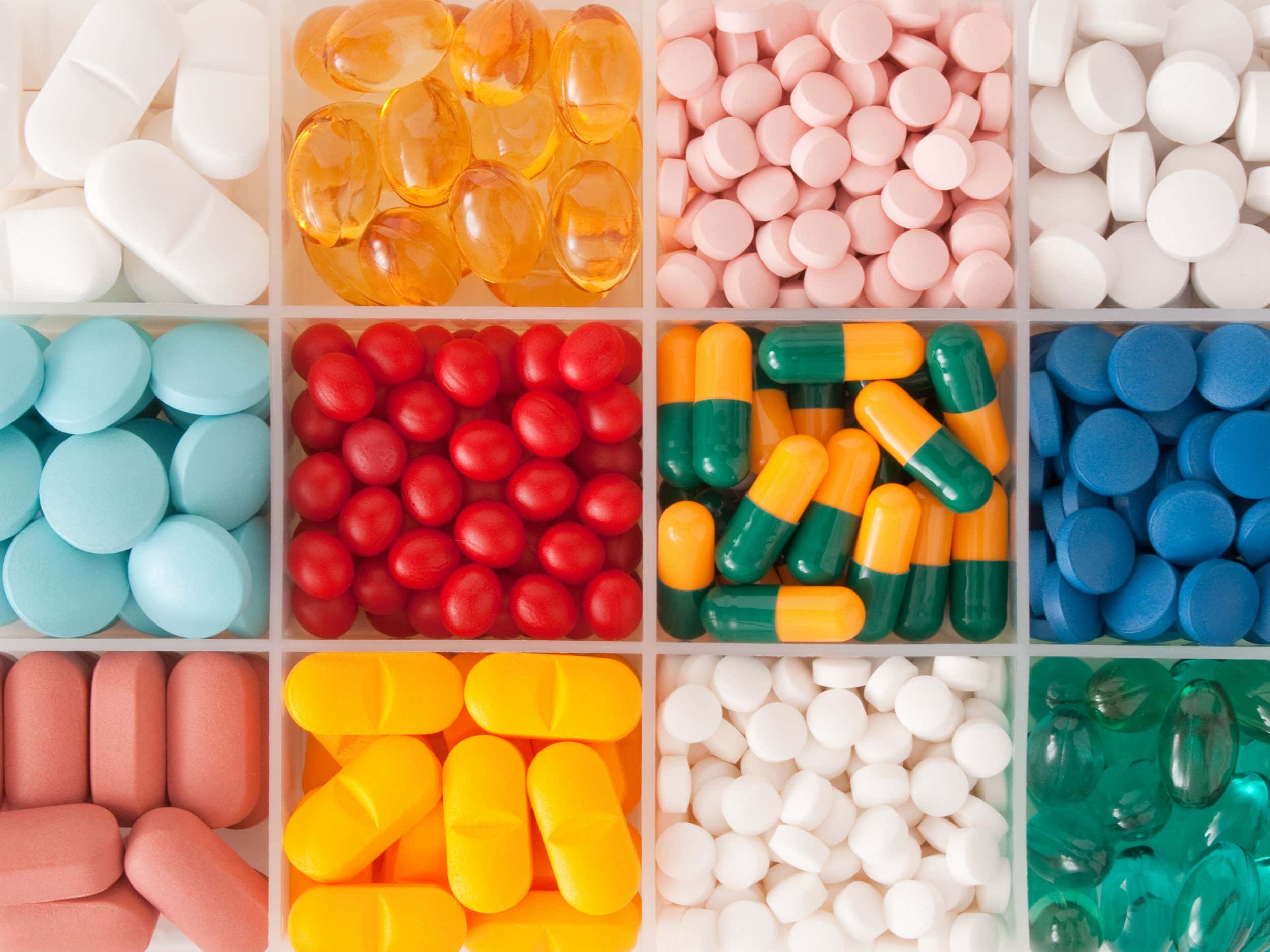 Top view of pills grouped in plastic container