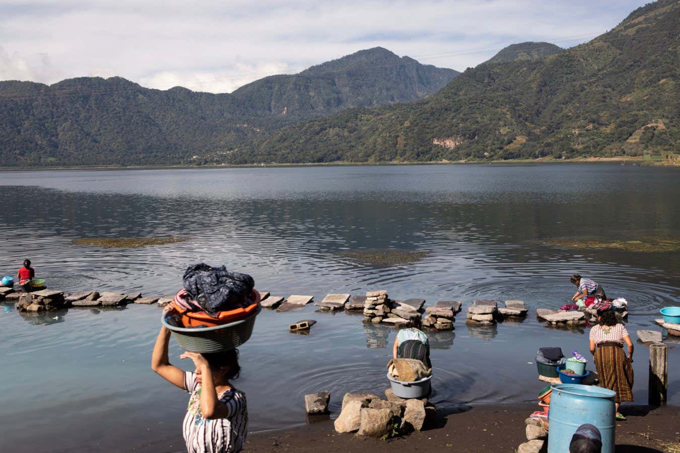 Guatemala - Atitl?n - Women washing their clothes in the lake surrounded by ancient volcanoes.