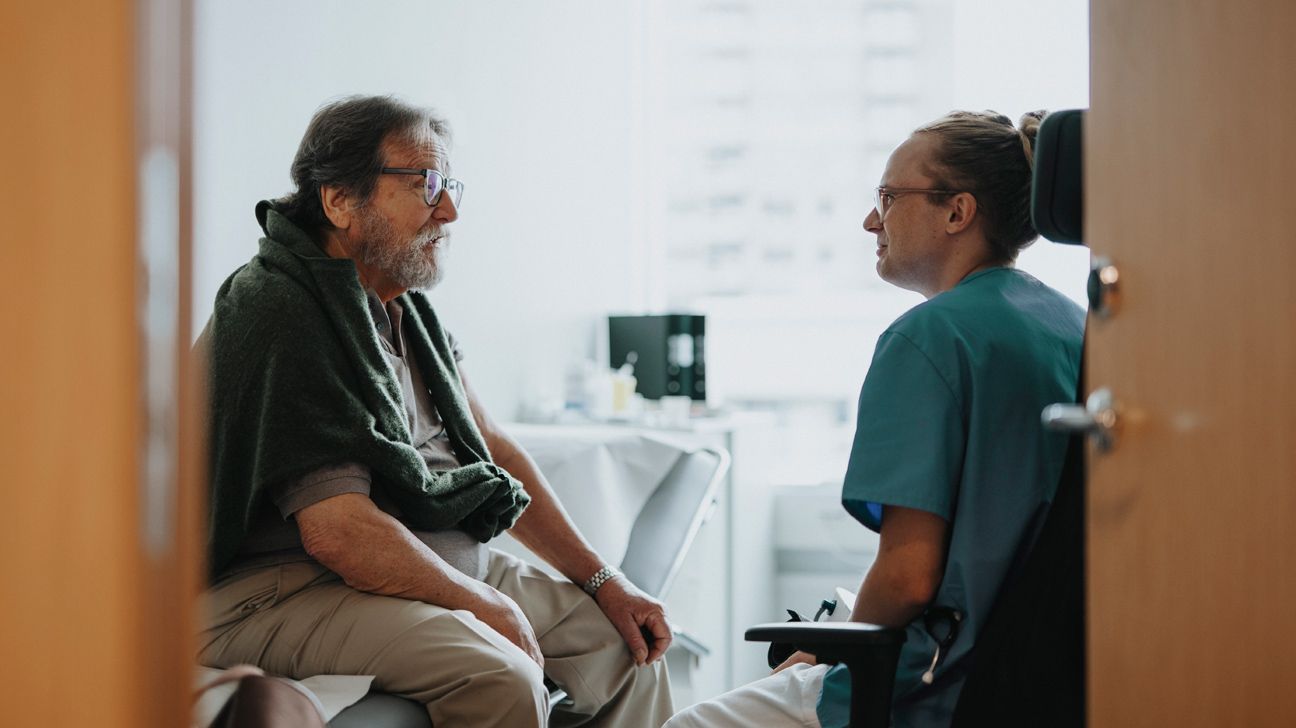 Older male talking with doctor