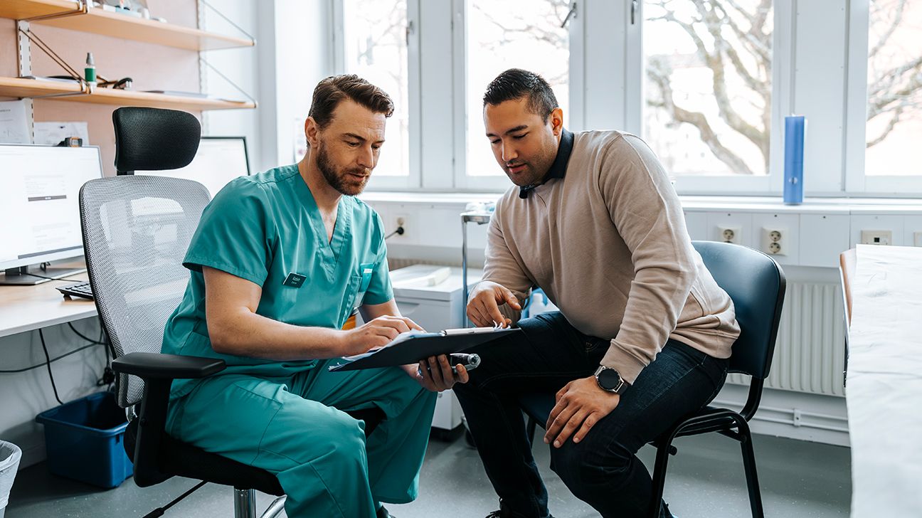 Male doctor explaining test results to male patient