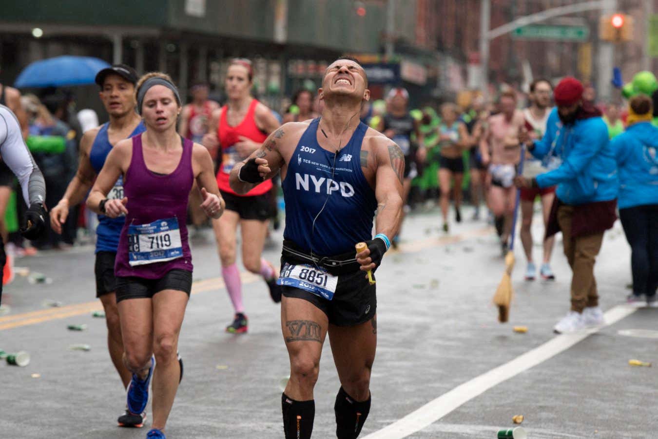 A runner near mile marker 20.2 in the Bronx grimaces in pain as he competes during the 2017 TCS New York City Marathon in New York on November 5, 2017. Five days after the worst attack on New York since September 11, 2001, the city is staging a show of defiance on November 5, as 50,000??runners from around the world are set to participate in the New York Marathon, under heavy security. (Photo by Don EMMERT / AFP) (Photo by DON EMMERT/AFP via Getty Images)