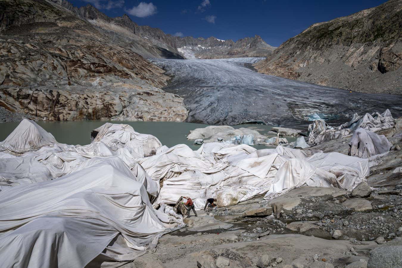 View from above Gletsch, in the Swiss Alps shows workers fixing insulating foam covering a part of the Rhone Glacier to prevent it from melting.