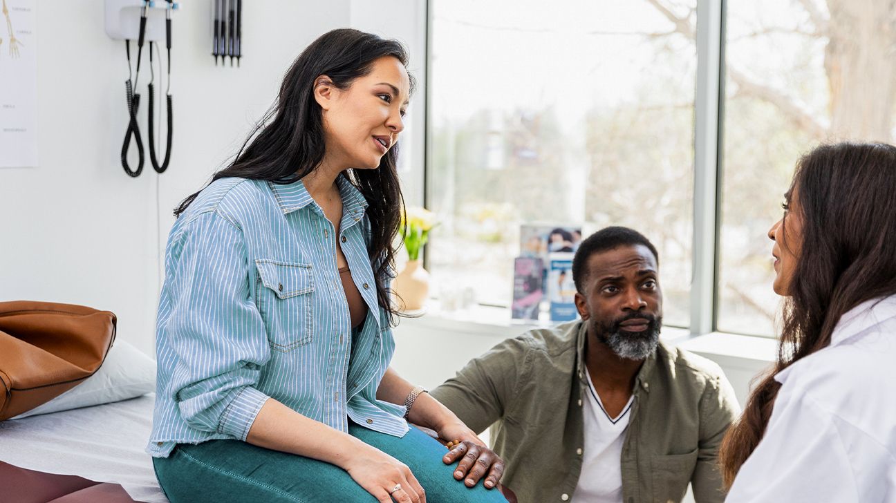 Patient and friend talking with doctor