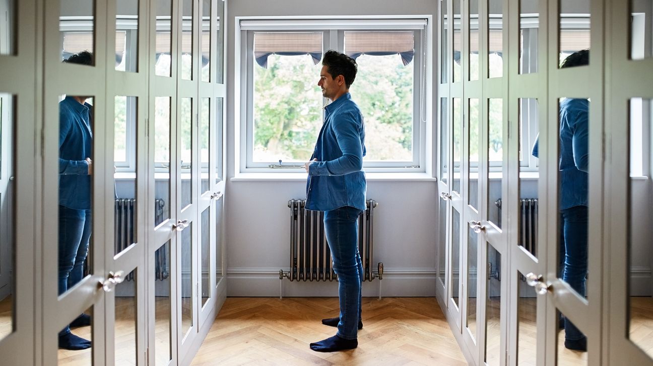 Male looks at himself in the mirror