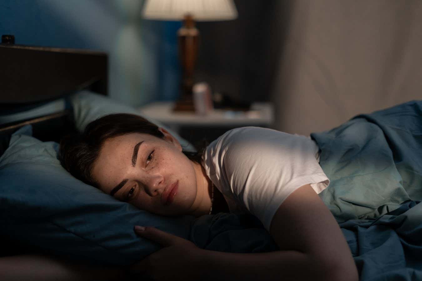 A woman lying awake in bed