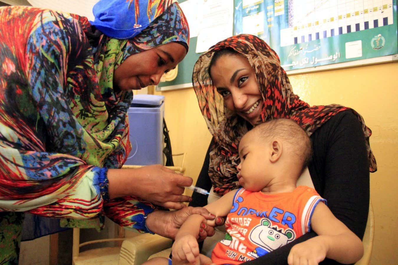 A health worker administers a measles vaccine to a child at a clinic in Khartoum Sudan