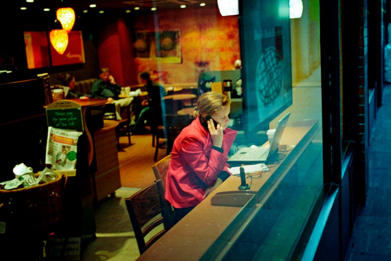 A person working in a cafe on a laptop