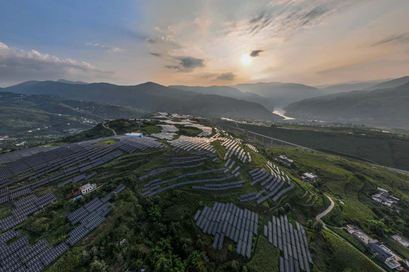 TOPSHOT - This photo taken on August 16, 2022 shows solar panels among Sichuan pepper field in Bijie, in China's southwestern Guizhou province. (Photo by AFP) / China OUT (Photo by STR/AFP via Getty Images)