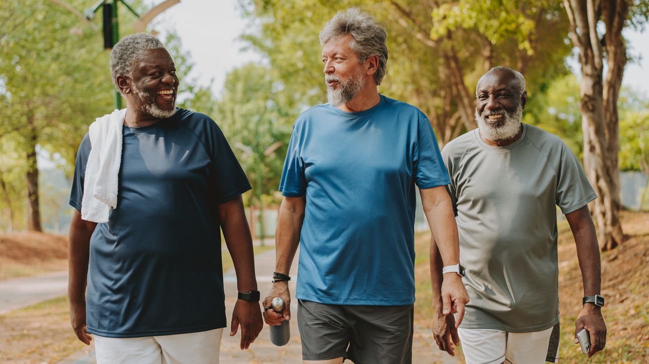 Male friends walking briskly outdoors