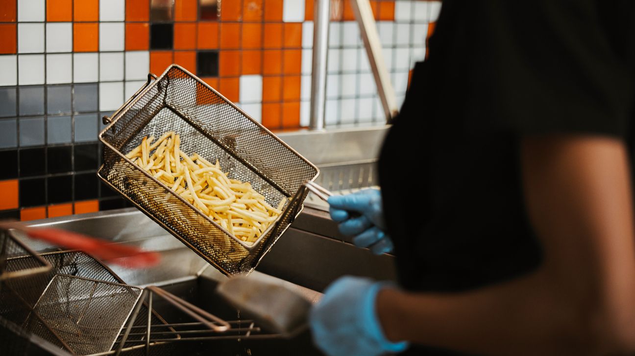 French fries being cooked in a fryer