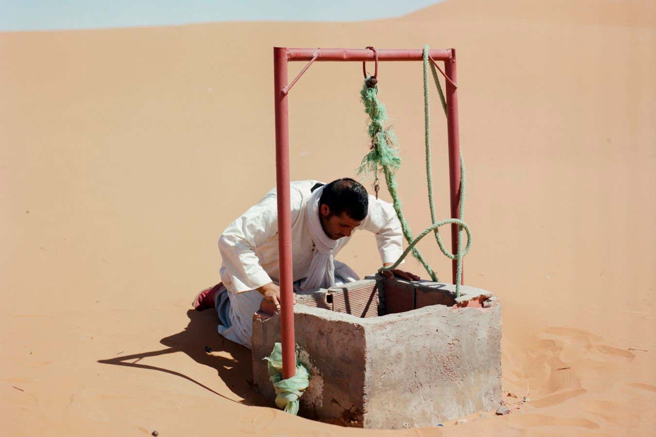 Man looking at the water level in the well M?hammed Kilito?s work ?Before it?s gone? is an ongoing photographic project documenting scenes of oases in Morocco. Morocco has lost two thirds of its oases in the last century to destructive human activities and climate change. To the artist, oases are the perfect model for sustainability, offering an ecological defence against desertification and a refuge for biodiversity. To artist M?hammed Kilito, the oasis is the perfect model of sustainability. Date palms, with their parasol-shaped foliage, create a humid microclimate and retain water in soil. This offers an ecological defence against desertification and a refuge for biodiversity. Before it?s gone is a long-term project documenting the complex issue of oasis degradation in Morocco and its impact on oases inhabitants. Morocco has been in a drought since 2018. Parts of the Sahara did not see rain for four consecutive years, while a flash flood killed dozens in the desert town of Ouarzazate in 2024. Kilito tells stories of farmers, scientists and citizen associations fighting to preserve these islands of greenery against increasingly threatening living conditions. Artist bio: M'hammed Kilito is a photographer and National Geographic Explorer based in Rabat. He is a contributing photographer to The VII Foundation, whose mission is to document the truth to empower communities worldwide to make evidence-based decisions about the challenges affecting their lives. He is represented internationally by Gowen Gallery. His artistic journey revolves around exploring the intricate connections and bonds that individuals and groups form with their environments - be it places of residence, memories, or transit points. M'hammed's work is dedicated to capturing narratives that provide insight into this profound connection, delving into subjects like cultural identity, labor sociology, and the impacts of climate change. M'hammed holds a Bachelor?s degree in Political Science from the University of Montreal and a Master?s degree in Political Science from Ottawa University. His photography has earned awards and grants from prestigious institutions, including World Press Photo Foundation, National Geographic Society, Magnum Foundation, and Prince Claus Fund, among others. His work has been featured in international media outlets such as The Washington Post, The Wall Street Journal, National Geographic Magazine, The British Journal of Photography and Vogue Italia, and has been exhibited around the world. He is a co-founder of KOZ, a collective he established with three other Moroccan visual artists to work on stories through in-depth, long-term projects.