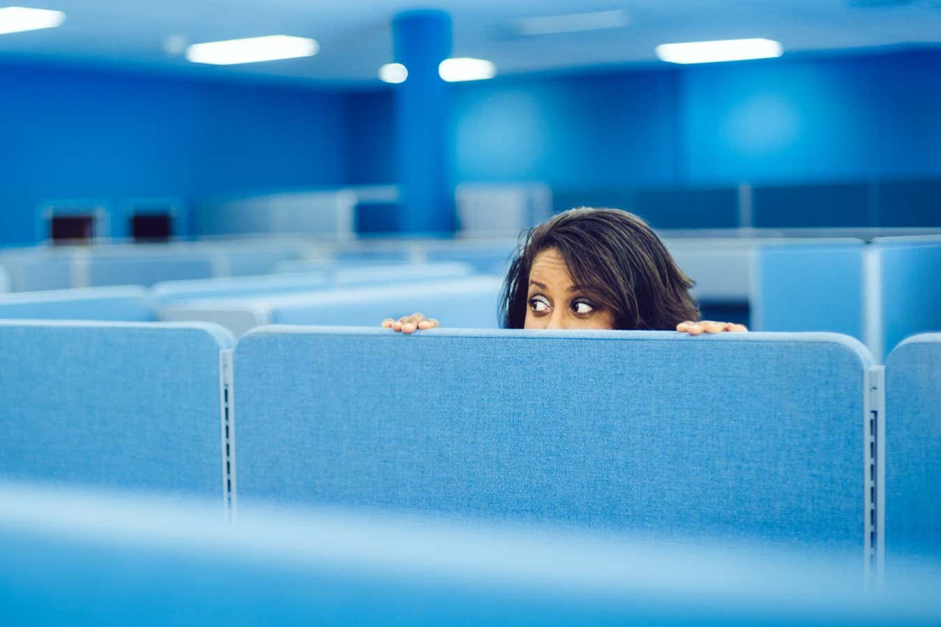 Office worker eavesdropping in cubicle room