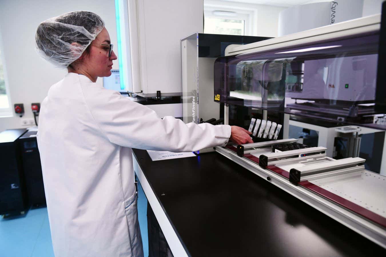 An employee inserts saliva samples into a machine in the Ziwig endometriosis analysis laboratory in Tercis-les-Bains, southwestern France, on March 25, 2024. (Photo by GAIZKA IROZ / AFP) (Photo by GAIZKA IROZ/AFP via Getty Images)
