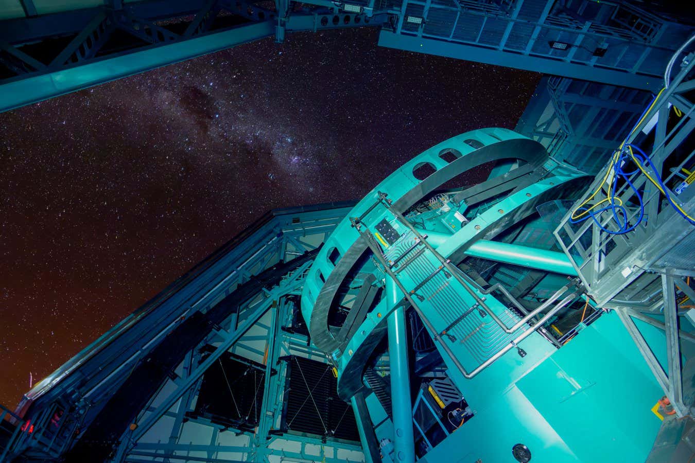 The Vera Rubin telescope, aimed at the open dome of the observatory, scanning the night sky.