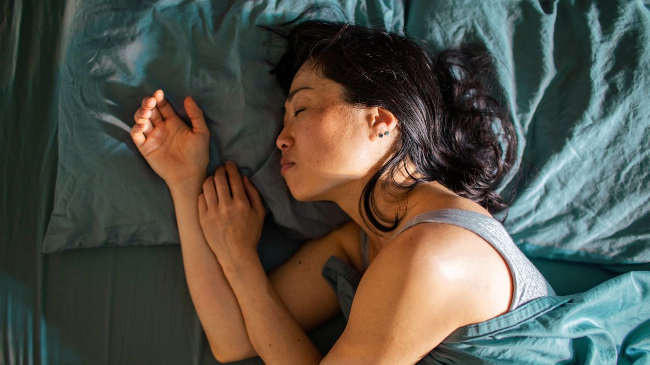 Female sleeping on bed in the morning