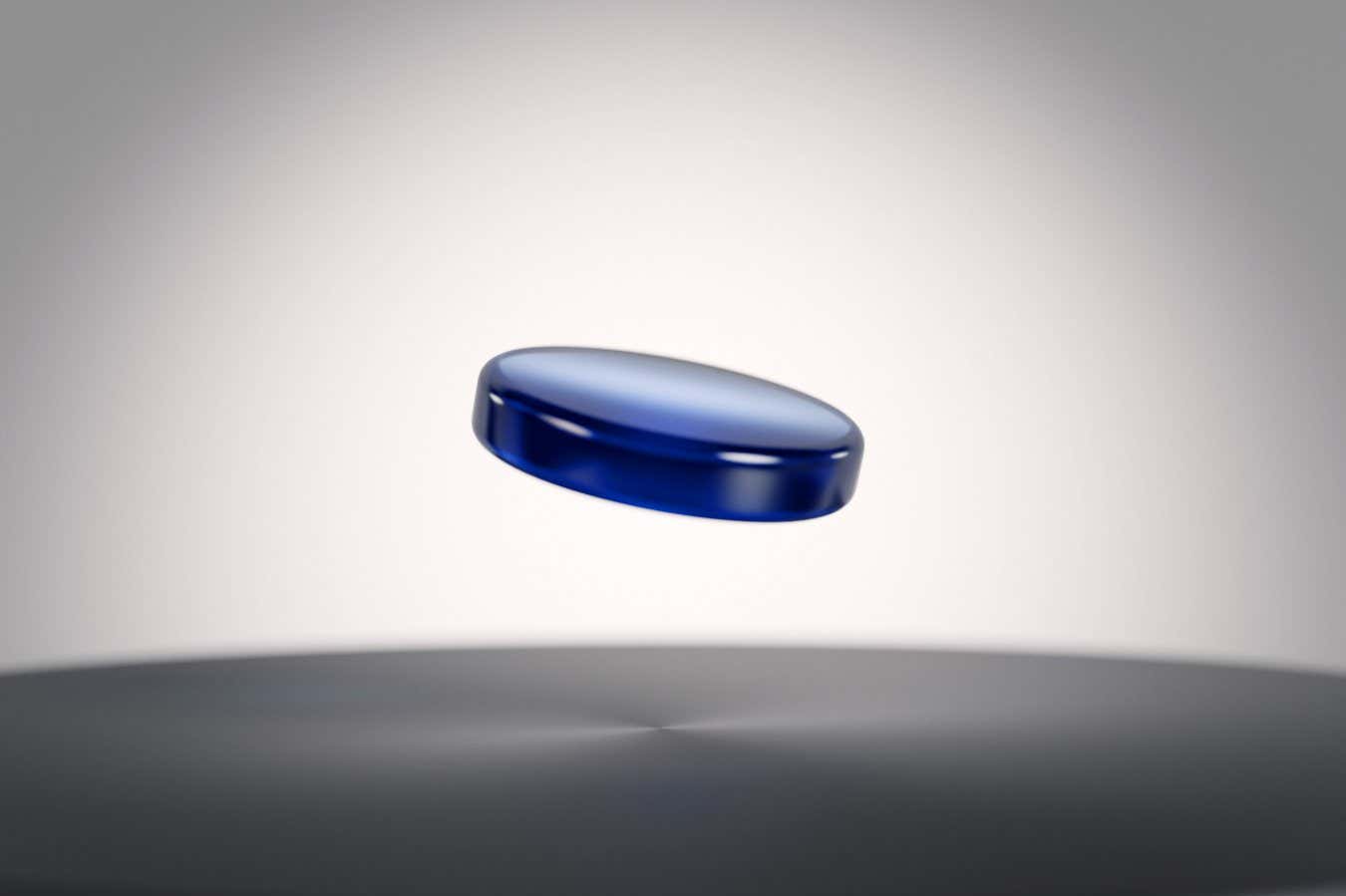 CGI illustration of a superconducting crystal LK99, perfect shape and colour, dark blue colour copper doped lead oxo apatite, floating over a magnet.; Shutterstock ID 2442898429; purchase_order: -; job: -; client: -; other: -