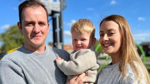 BBC Reah Steer and her husband Jono holding their young son