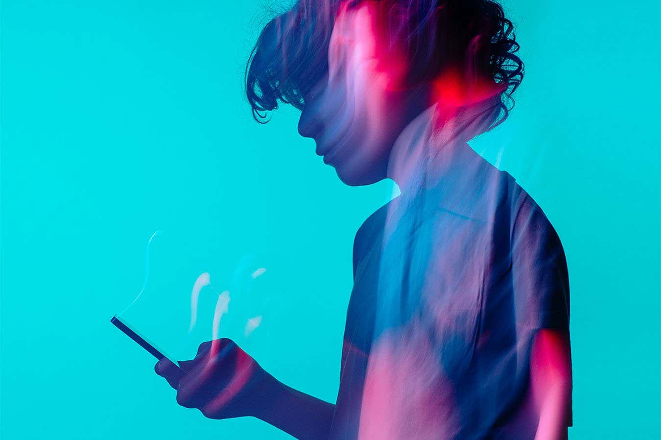 a teenager holding a cell phone in his hand