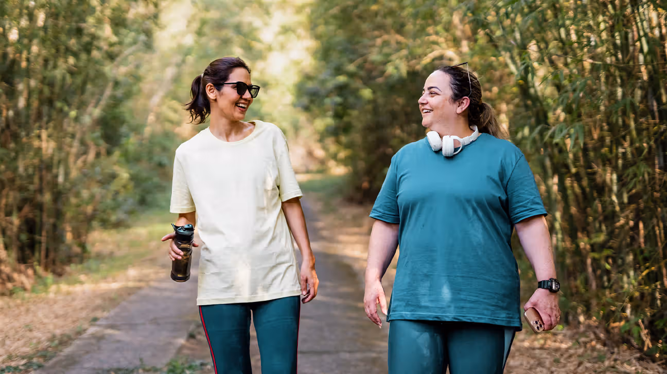 Female friends walking briskly outdoors