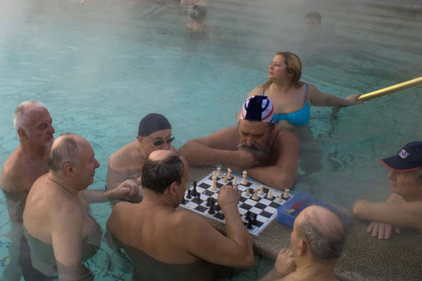 A group of people playing chess in thermal bath. Socialising and other lifestyle factors can delay Alzheimer's onset 