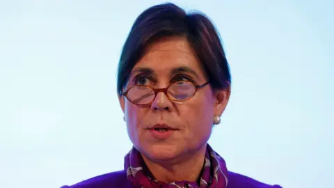 Getty Images A head shot of Baroness Kate Lampard, peering over the top of small circular-framed glasses and wearing a pashmina