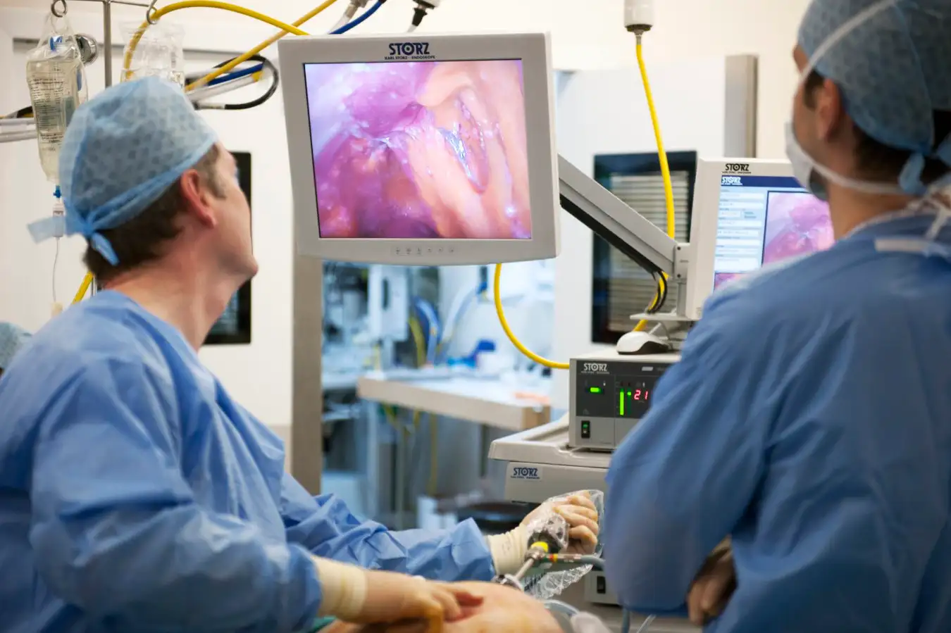 Ovarian cancer surgery. Surgeons performing laparascopic (keyhole) surgery on a 58-year-old woman with ovarian cancer. This patient was diagnosed 6 months previously and treated with surgery and chemotherapy. An initial computed tomography (CT) scan showed a small abnormal mass but this laparascopic procedure reveals massive widespread metastatic (spread) disease.