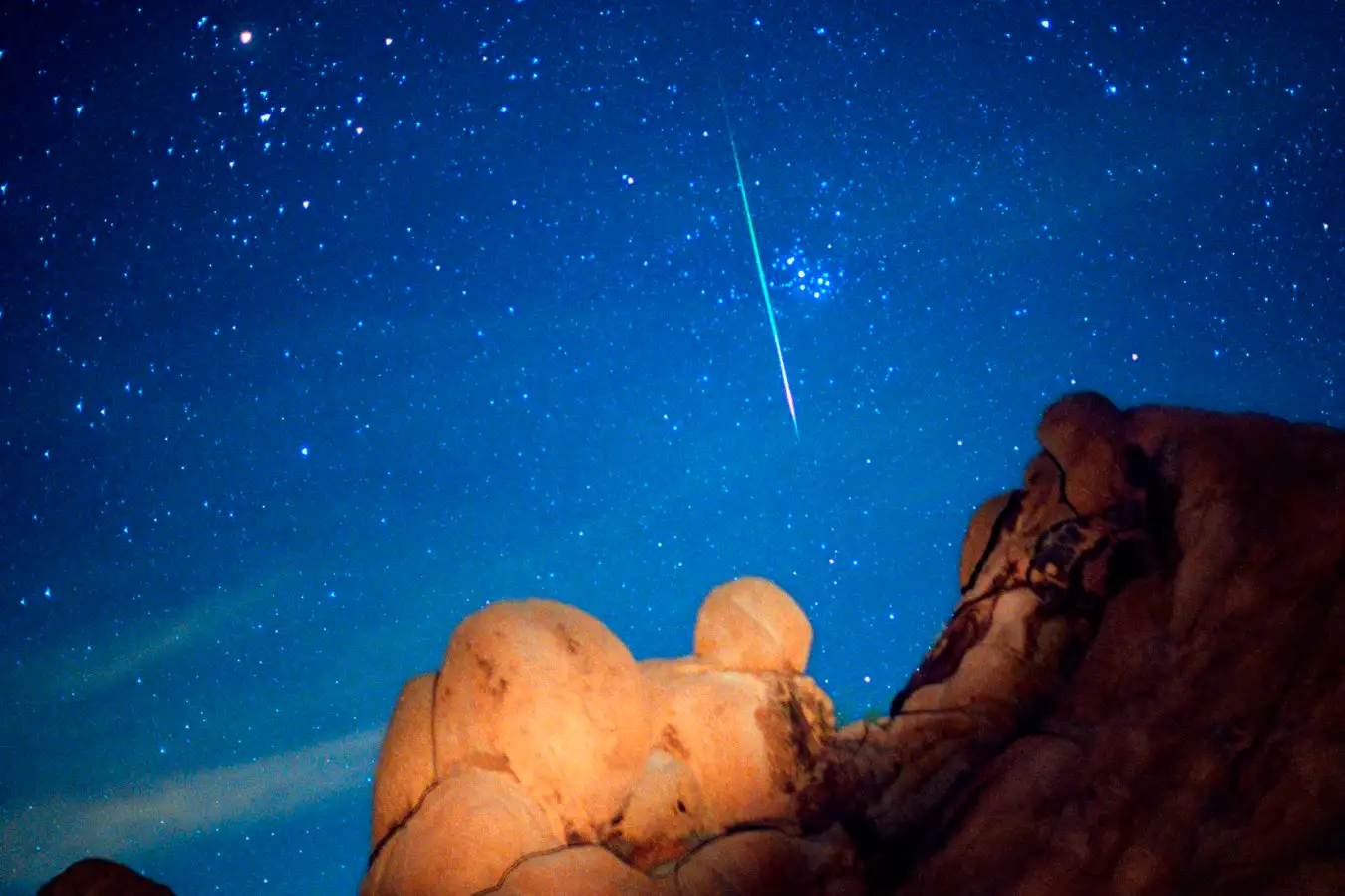 This image may not be used on retail merchandise in the U.S.A. Leonid meteor and Pleiades star cluster. Optical image of a Leonid meteor (bright streak) to the left of the Pleiades star cluster. Meteors, or shooting stars, are tiny particles of dust which enter the Earth's atmosphere with speeds of 35-95 kilometres per second. Air resistance heats the particles, making them visible as streaks of light. The Leonid meteor shower occurs annually around 17th November when the Earth crosses the path of debris produced by the Tempel-Tuttle 1886 I comet. The Pleiades (Seven Sisters) star cluster contains about 3000 stars. It is about 390 light years from Earth in the constellation Taurus.